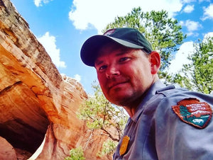 Element Outdoors owner Travis pictured in a park ranger uniform from his time working in Arches National Park